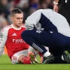 Arsenal's Leandro Trossard receives treatment for an injury 