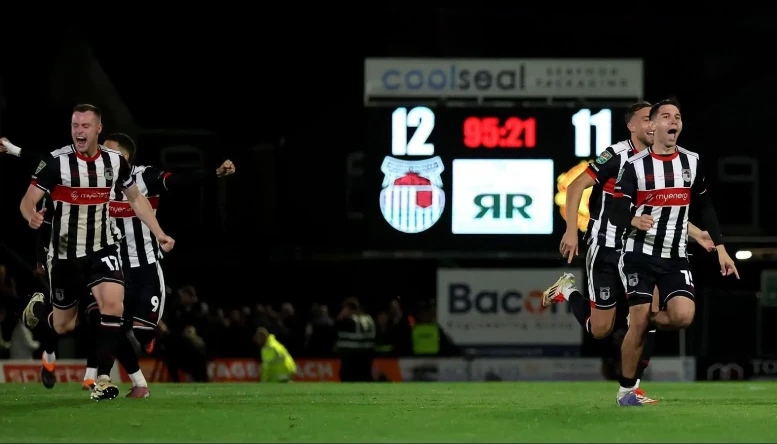 Grimsby Town’s players celebrate defeating Manchester United