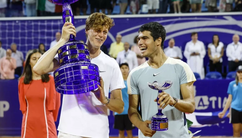 Jannik Sinner and Carlos Alcaraz pose with trophies