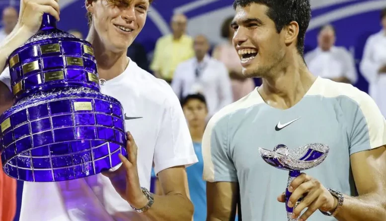 Jannik Sinner and Carlos Alcaraz pose with trophies