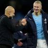 Manchester City manager Pep Guardiola speaks with Erling Haaland 