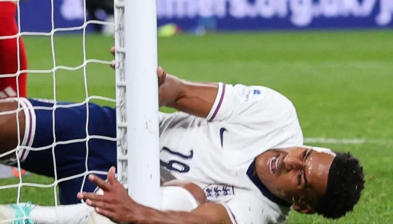 Ollie Watkins of England collides with the post and injures himself
